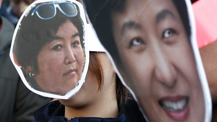 South Korean protesters wear cardboard masks of President Park Geun-hye