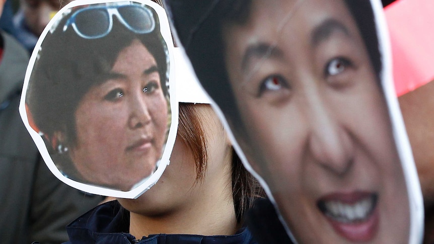 South Korean protesters wear cardboard masks of President Park Geun-hye