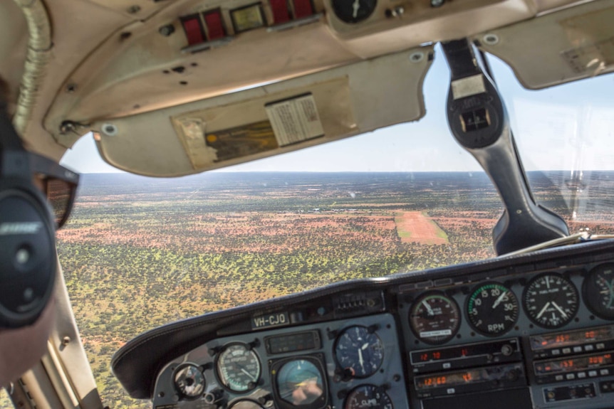 Looking out of the cockpit of a small charter plane towards an airstrip