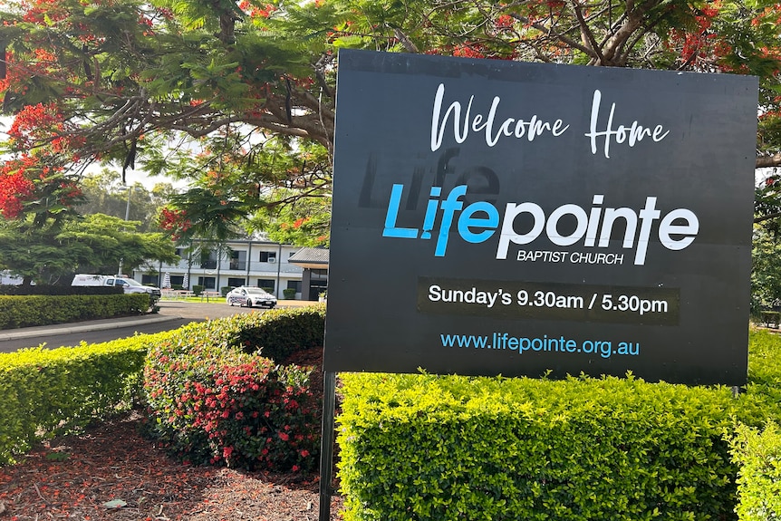Sign reading Lifepointe Baptist Church with white building in background