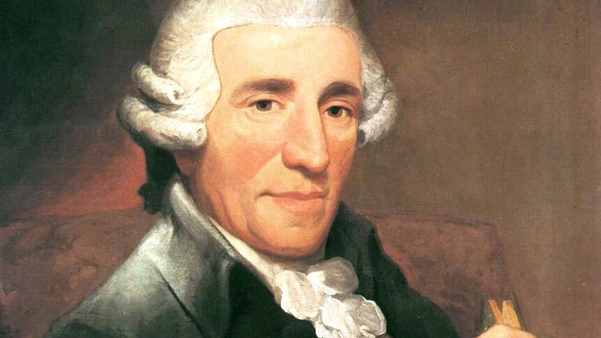 A portrait of composer Joseph Haydn in a white wig, holding a closed book.