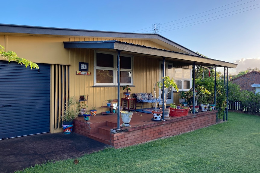 Yellow and blue home with brick verandah
