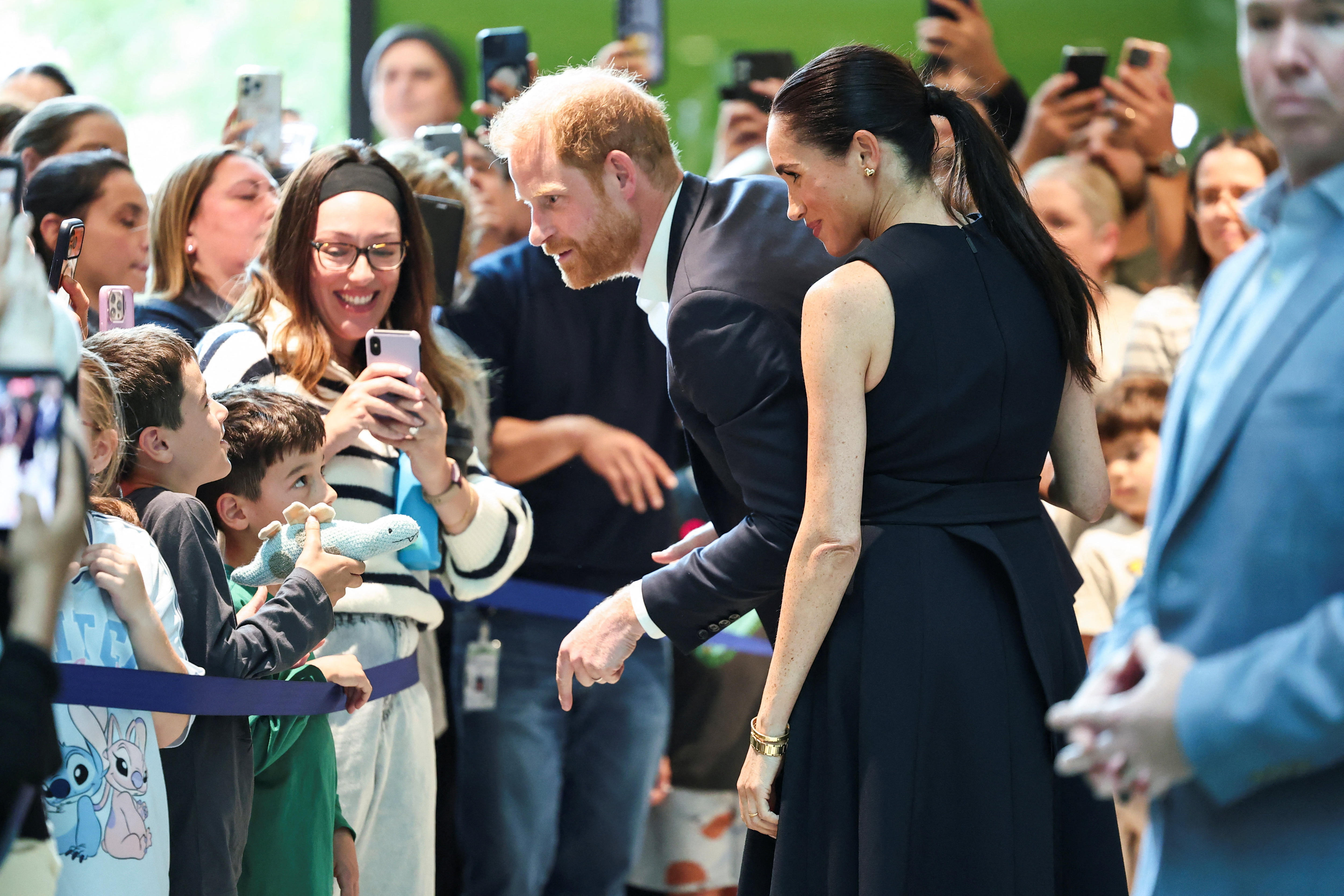 Harry and Meghan speak with children at the Royal Children's Hospital in Melbourne.
