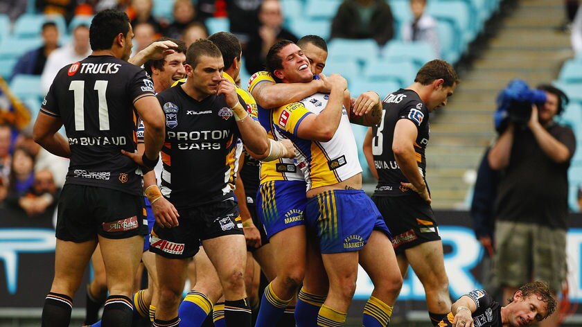 Massacre... the Eels celebrate another try over the hapless Tigers.