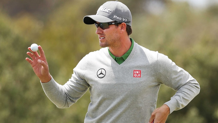 Adam Scott makes a putt during round three of the Australian Masters.