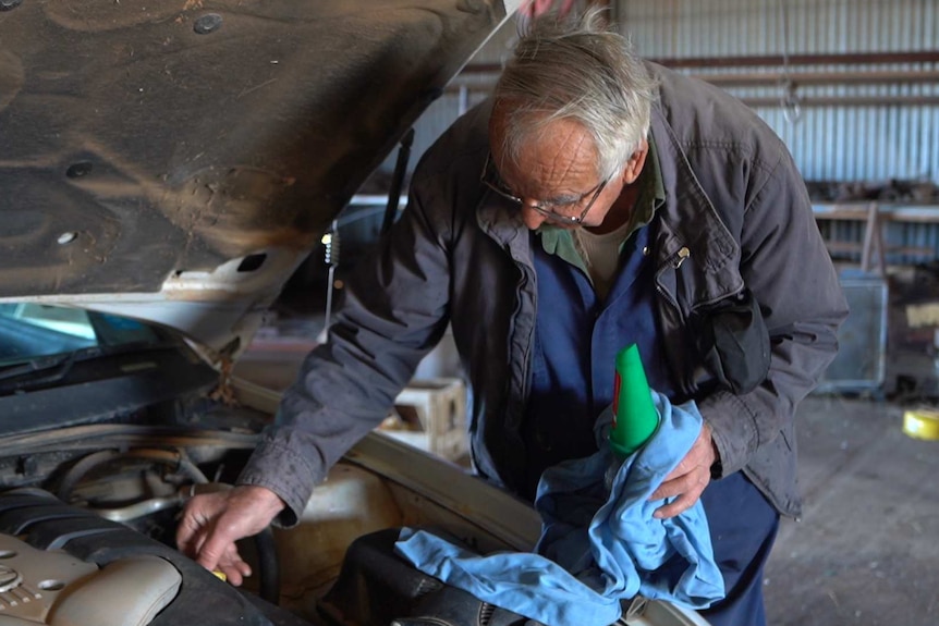 Mechanic Maurice Henry works on car