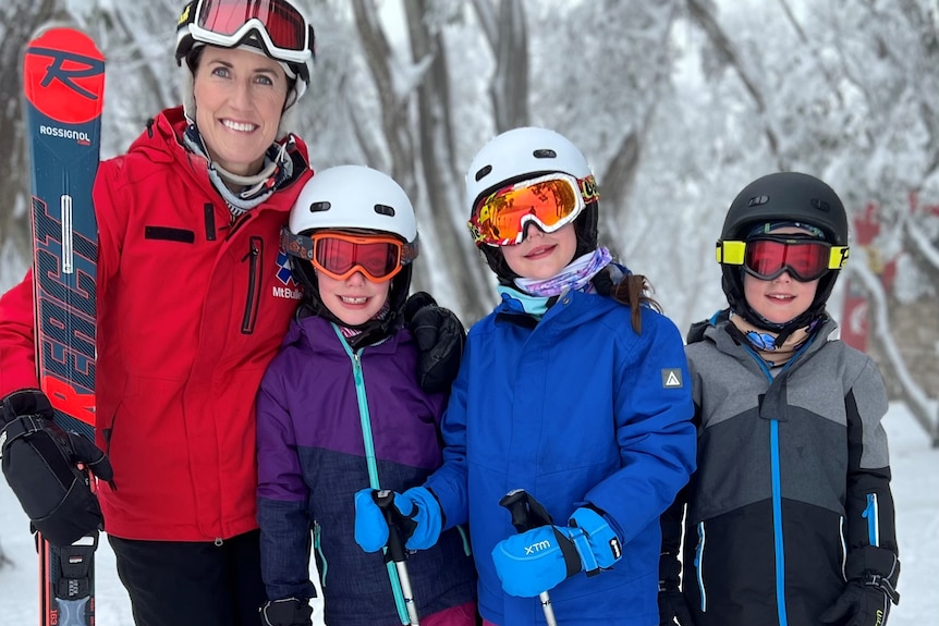 A woman with children at a ski field