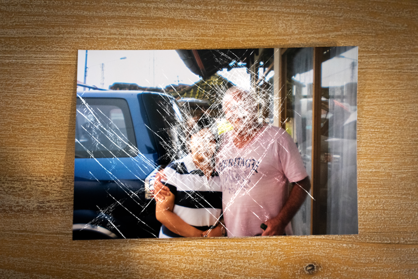 A photo of a man and a woman with their faces scribbled out.