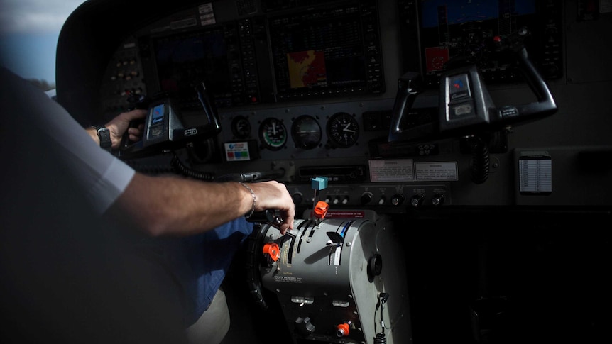 A pilot's hand on the controls of a remote flight in WA.