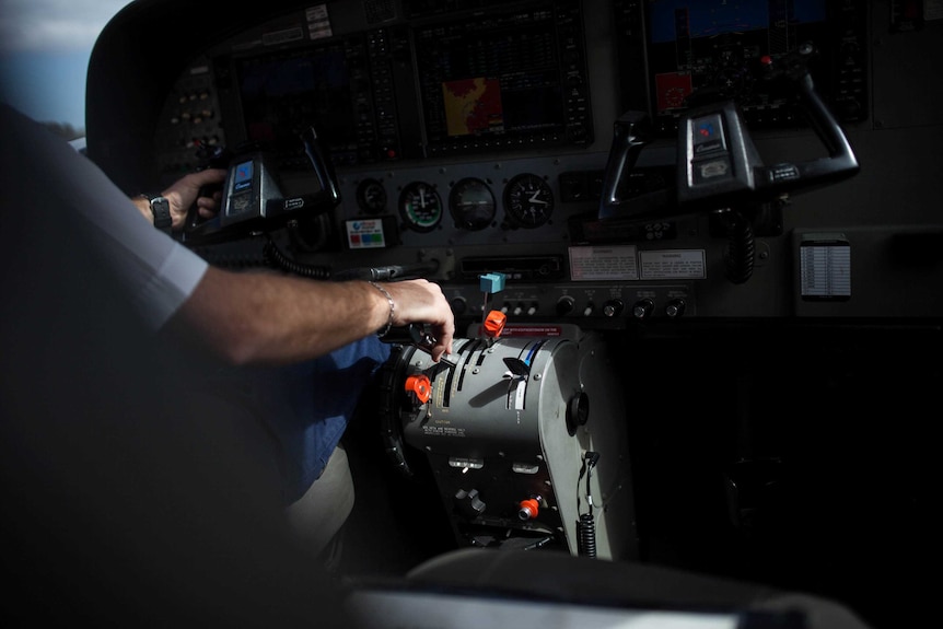 A pilot's hand on the controls of a remote flight in WA.