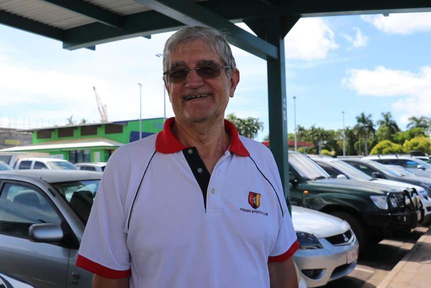 Retiree Jim Arthur smiles at the camera in the car park of a Darwin shopping centre.