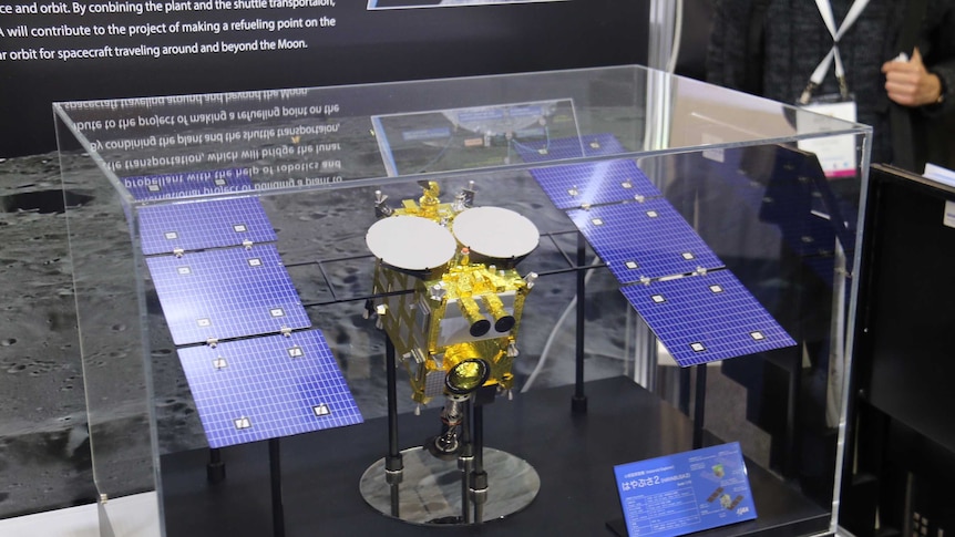 An asteroid explorer model in a glass display