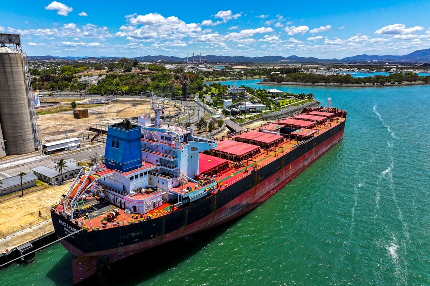 aerial view or a large ship parked in a port