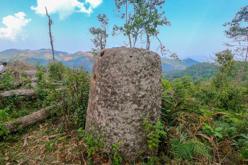 A stone jar on a leafy hillside