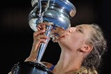 Victoria Azarenka kisses the winner's trophy after her victory over Maria Sharapova.