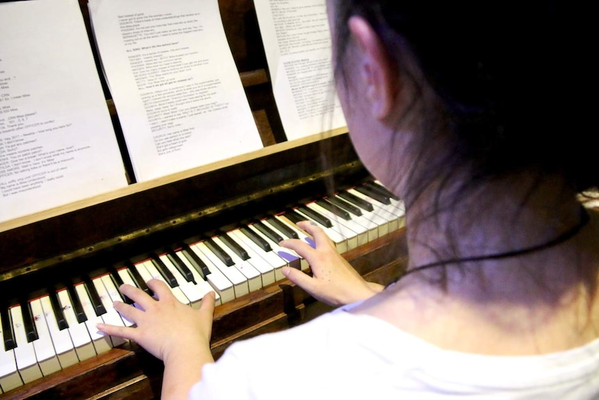 An unidentified woman plays the piano in the gym at Dame Phyllis Frost Centre.