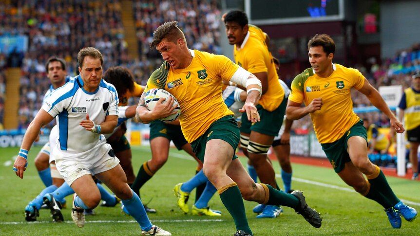 Not holding back ... Sean McMahon crosses for a try during the Wallabies' pool match against Uruguay