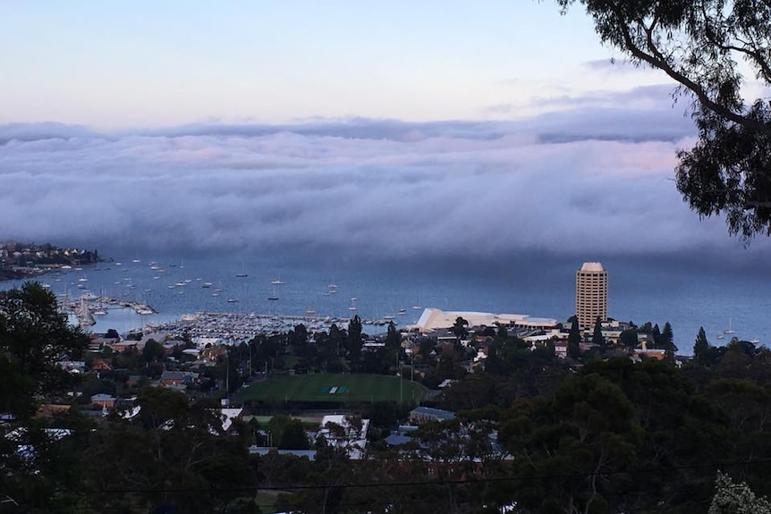 Christmas Eve fog rolls in over Hobart, seen from Mount Nelson.