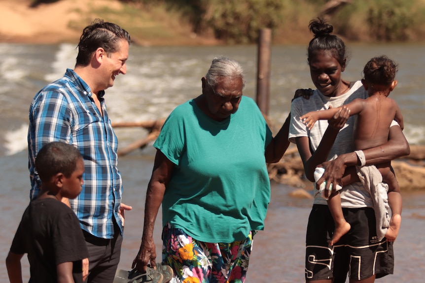 Dan Bourchier with Miriam-Rose Ungunmerr-Baumann and kids in her community