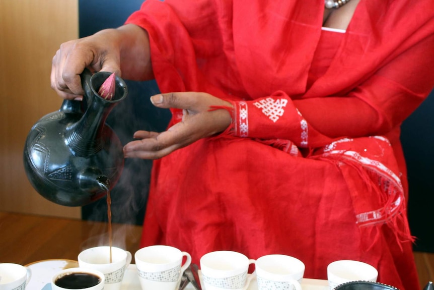 Pouring coffee during a traditional Ethiopian coffee ceremony.