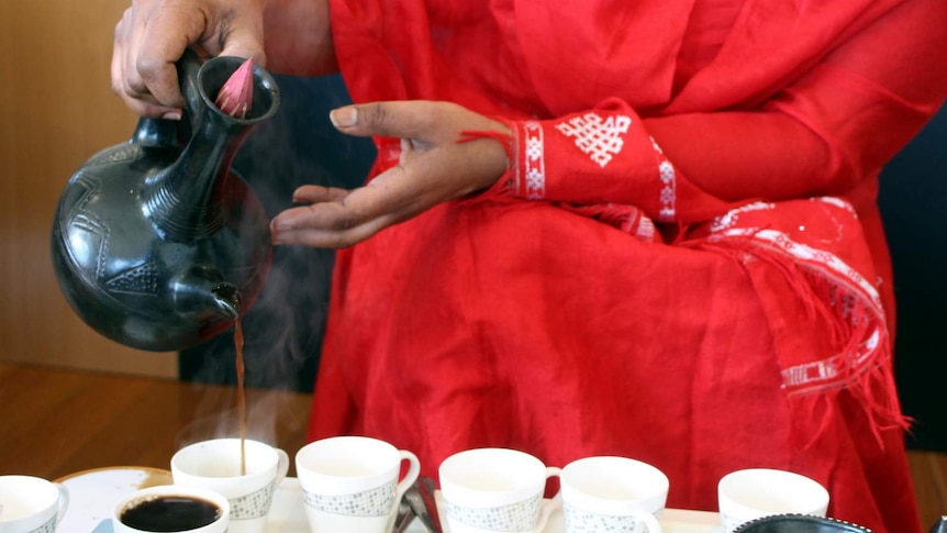 Pouring coffee during a traditional Ethiopian coffee ceremony.