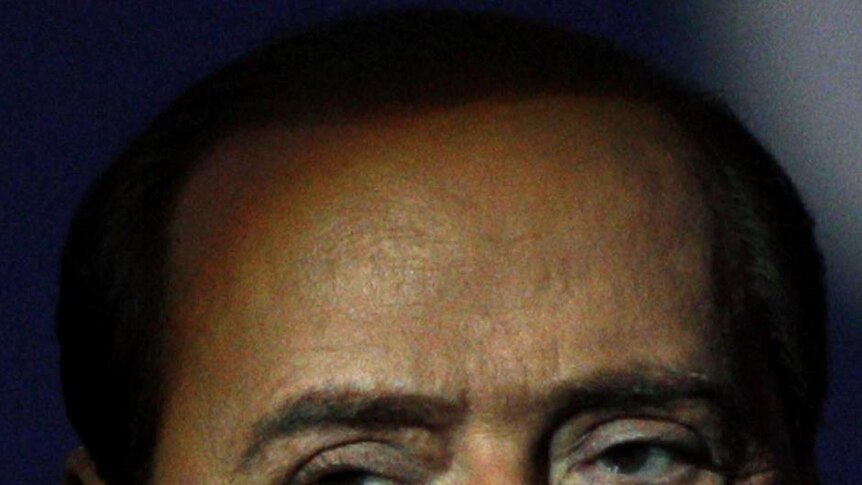 Italy's Prime Minister Silvio Berlusconi looks on before the taping of a TV show