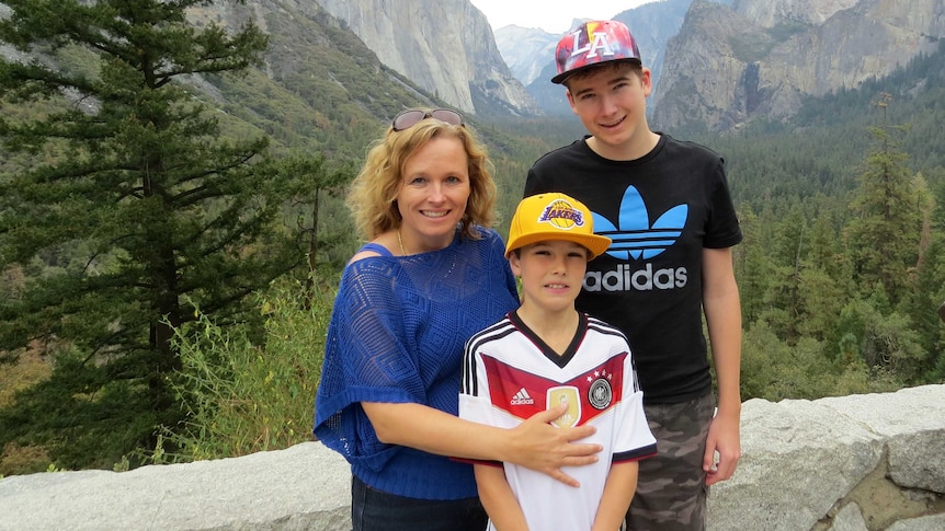 Dyslexia support advocate Tanya Forbes and her sons Brendan and Connor against a mountainous backdrop.