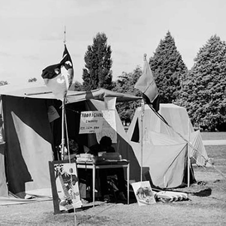 Flags fly in front of the Aboriginal Tent Embassy