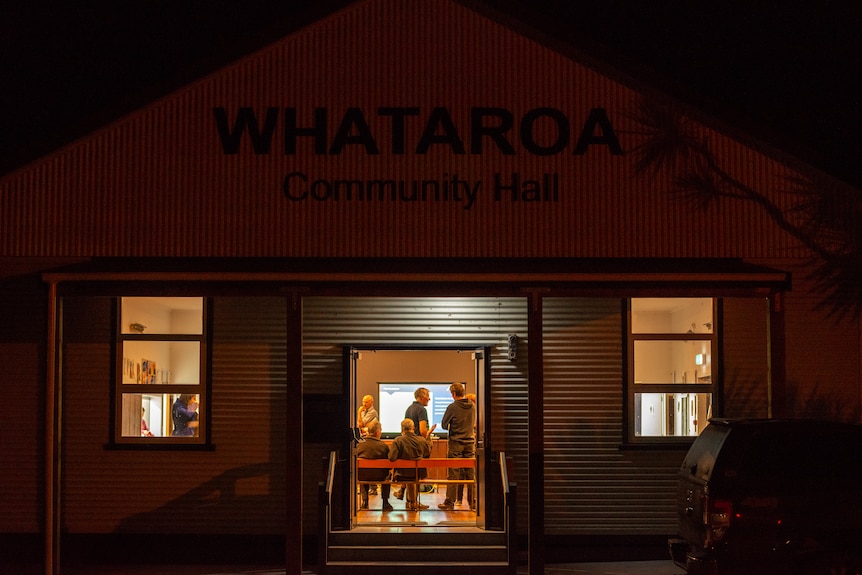 The well-lit inside of the hall can be seen from outside. 