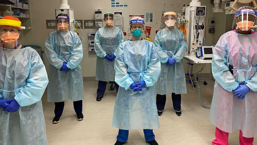 Six nurses wearing personal protective equipment.