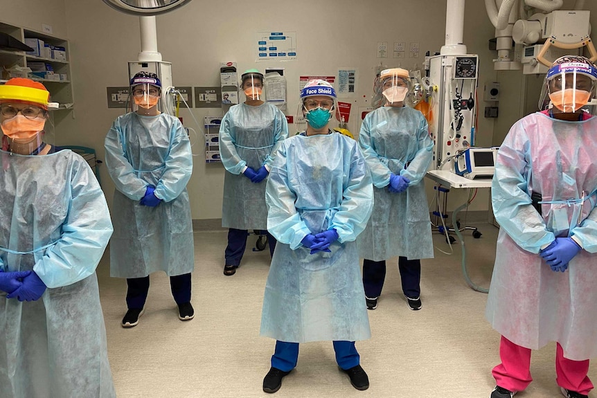 Six nurses wearing personal protective equipment.