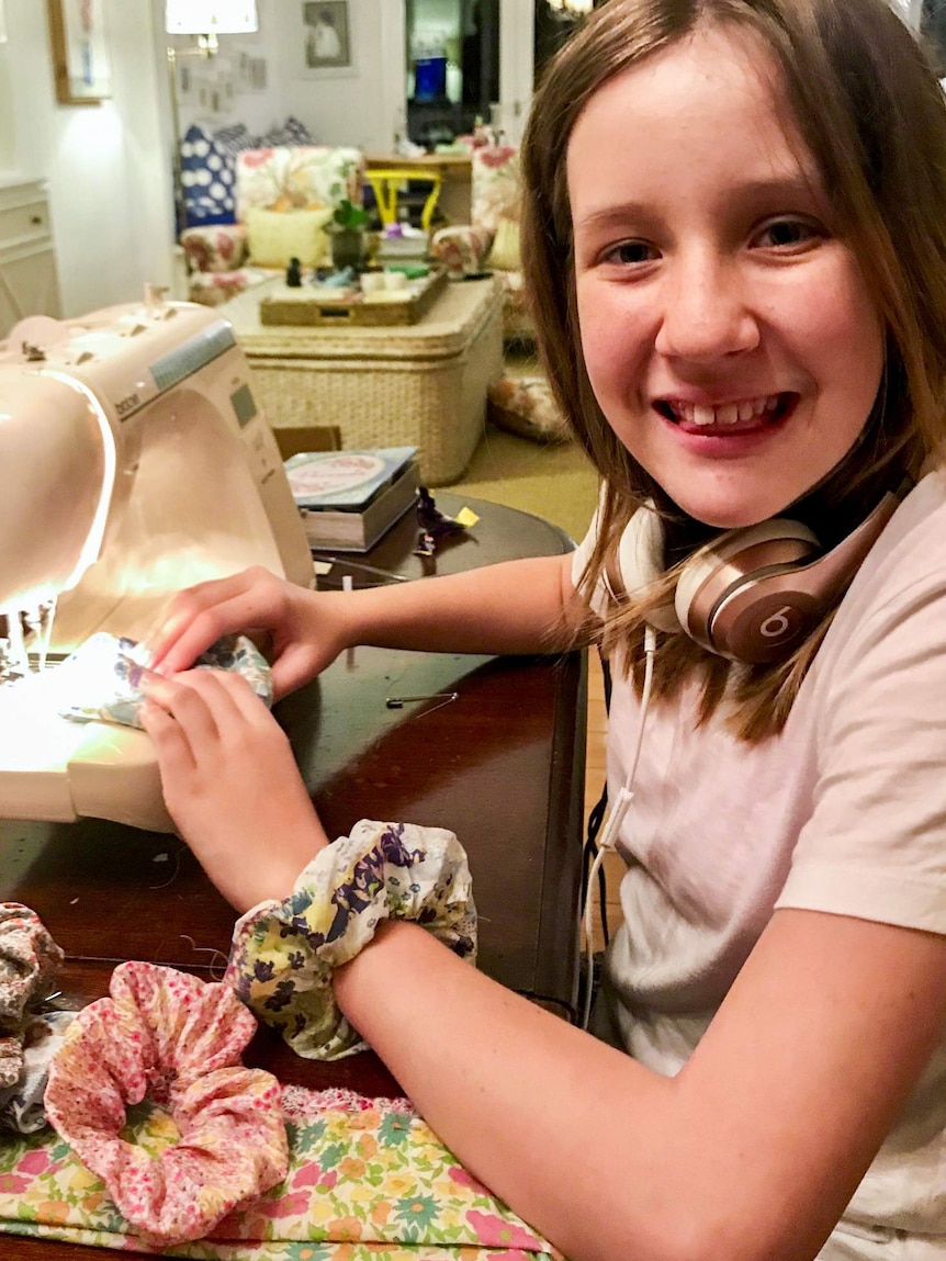 Young girl sewing scrunchie hair ties.