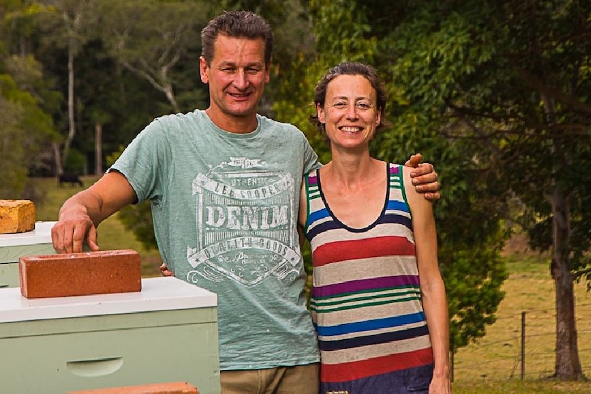 Beekeepers Sven and Ana Martin next to some of their beehives.