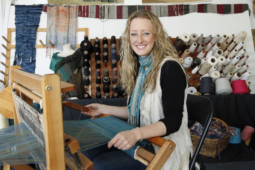 Prue Simmons weaving textiles  on a loom
