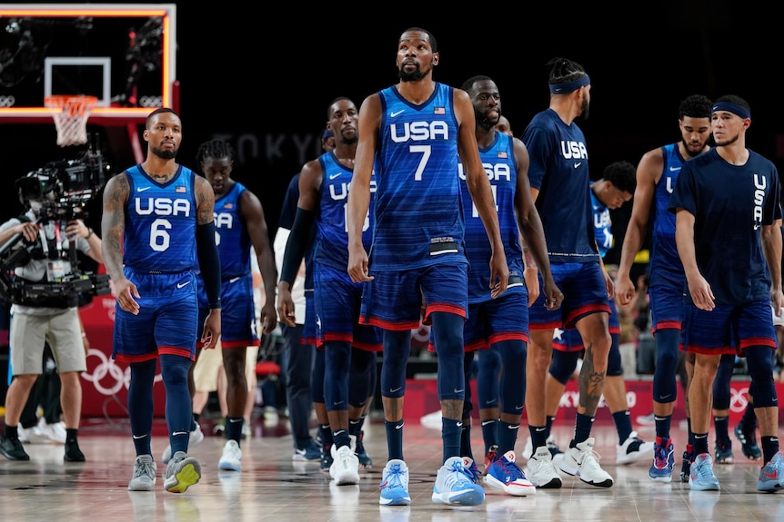 The USA basketball team walks off the court after a loss against France in a group game at the Tokyo Olympics.
