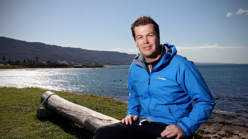 Corey Pearson sits on a bench at Bulli Beach point.