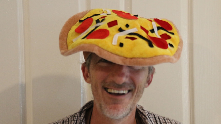 Wayne Morris wears his pizza hat.