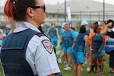Prison officer watching on as inmates at Brisbane Women's Correctional Centre get ready to run in the background
