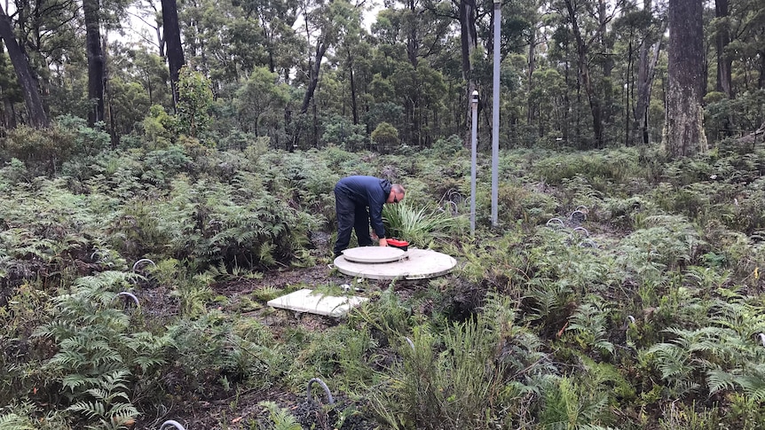 Geoscience Australia Senior Technical Officer Thomas Stokes conducts maintenance in the infrasound receiver in Tasmania