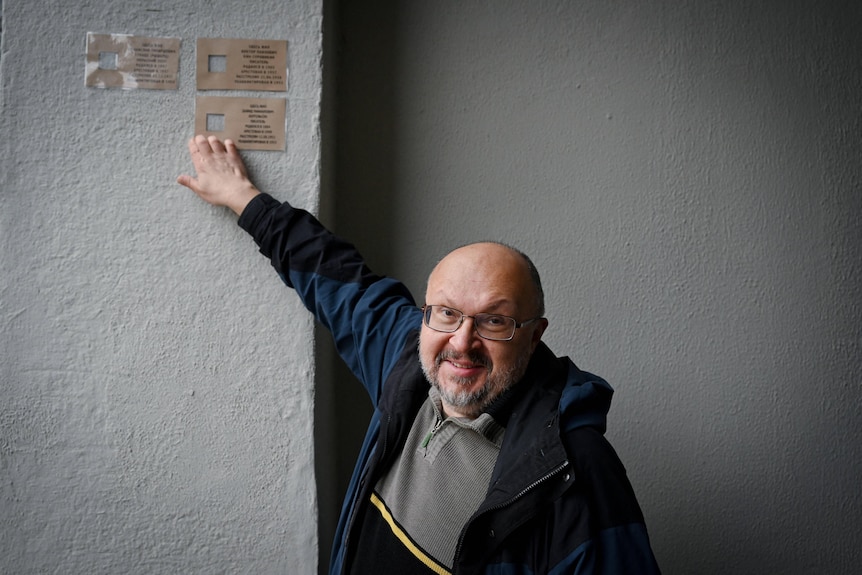 Alexei Orlov puts up handmade cardboard cards to replace metal plaques.