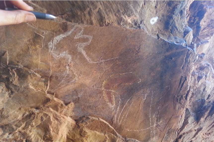 Painting on a rock appears to show an animal or kangaroo.