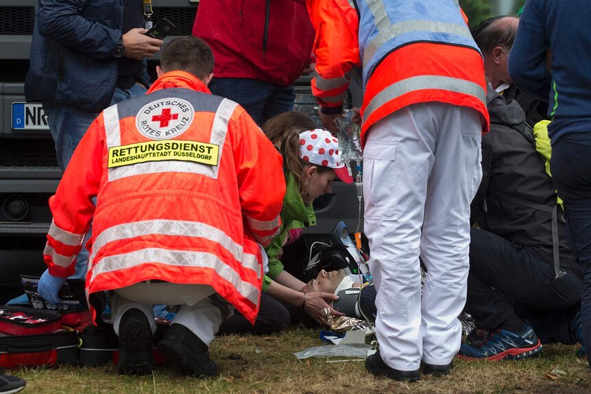 Medics attend to Spain's Alejandro Valverde as he lies on the ground after crashing during the Tour de France.