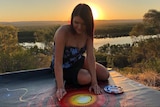 Indigenous artist Chern'ee Sutton working on a painting.
