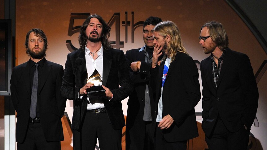 Dave Grohl accepts a Grammy trophy