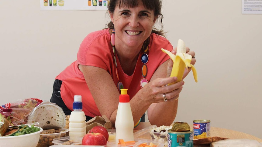 a woman surrounded by food in a clinic room