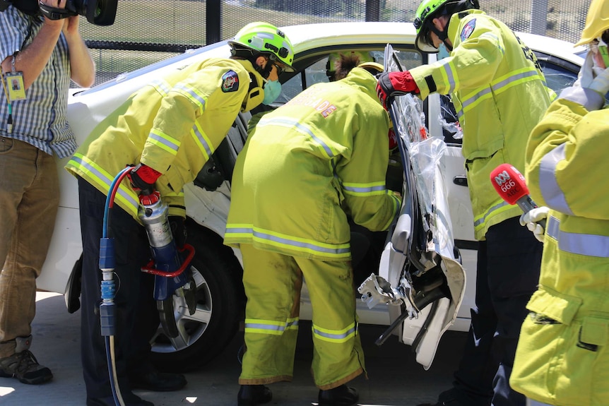 Using the jaws of life to free a Canberra Times journalist from a car.