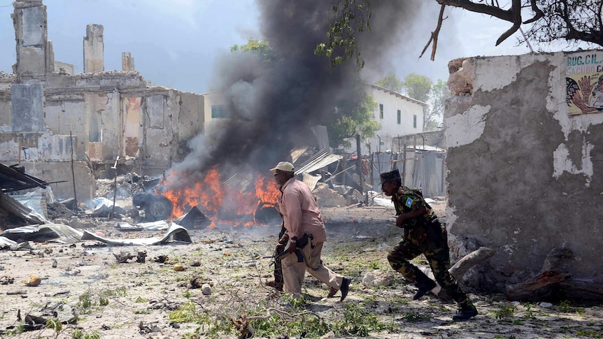 Somali police run for cover in Mogadishu.