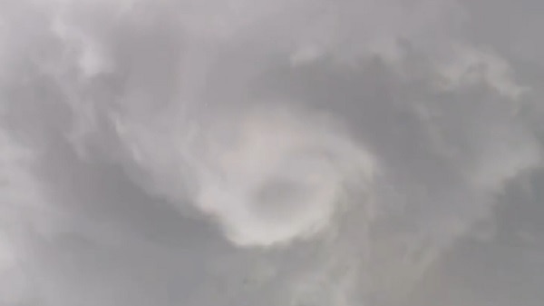 Land spout spirals in cloud formation