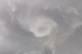 Land spout spirals in cloud formation