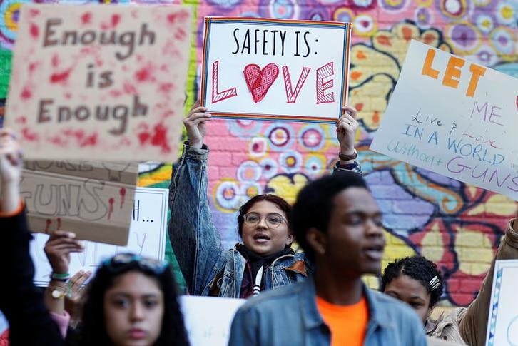 students hold signs during walk out protest